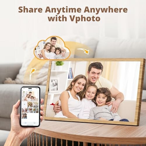 Person holding smartphone showing photos, digital photo frame with family picture on table.