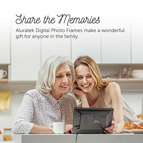 Two women enjoying a digital photo frame in the kitchen.