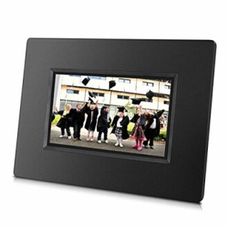 Digital photo frame displaying children in graduation attire.