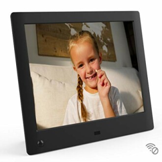 Digital photo frame displaying a smiling child.