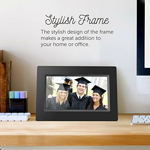 Digital photo frame on desk displaying graduates.