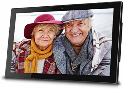 Elderly couple smiling in a photo frame.