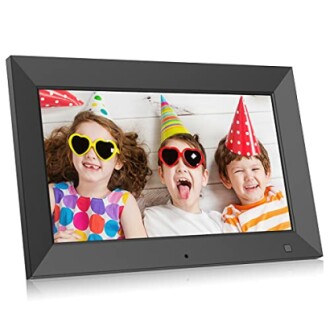 Three children wearing party hats and sunglasses in a photo frame.